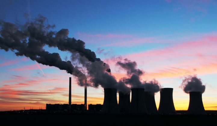 A coal-fired power plant at sunset.