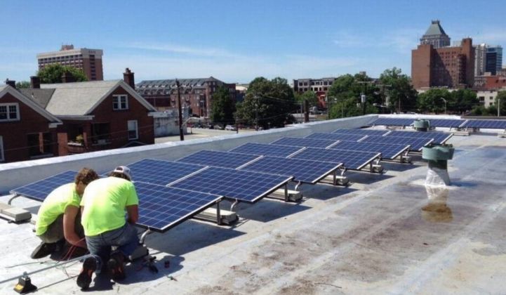 Workers install solar on the roof of a church in Greensboro, North Carolina.