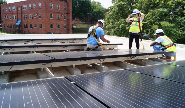 Women installing rooftop solar for GridAlternatives