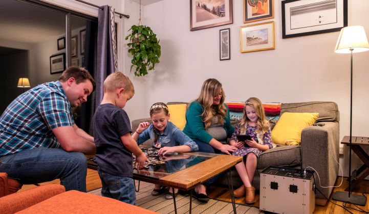 A family uses a Humless battery pack to keep the lights on when the grid is down. (Photo courtesy of Humless)